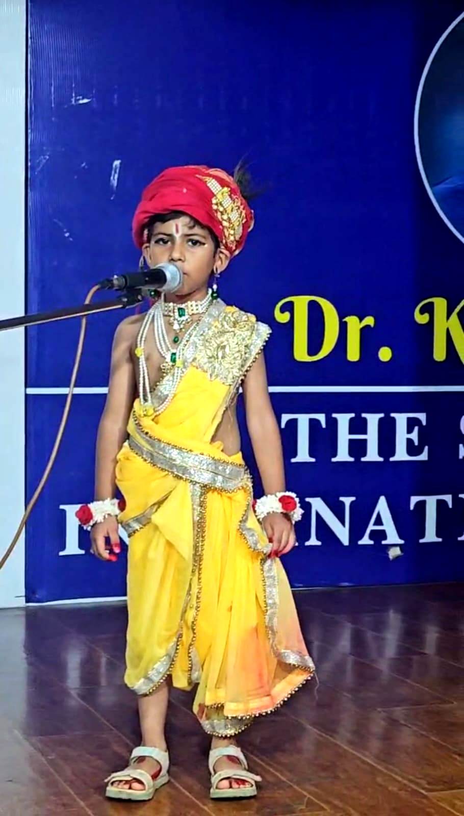Primary students speaking confidently during a school speech competition.